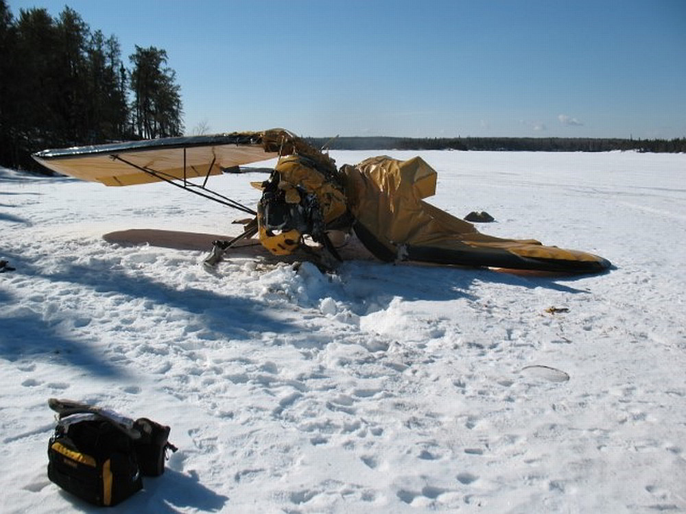 A Piper J3C-65 aircraft on skis collided with terrain on landing at Snowshoe Lake