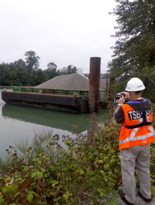 TSB investigator photographing the barge