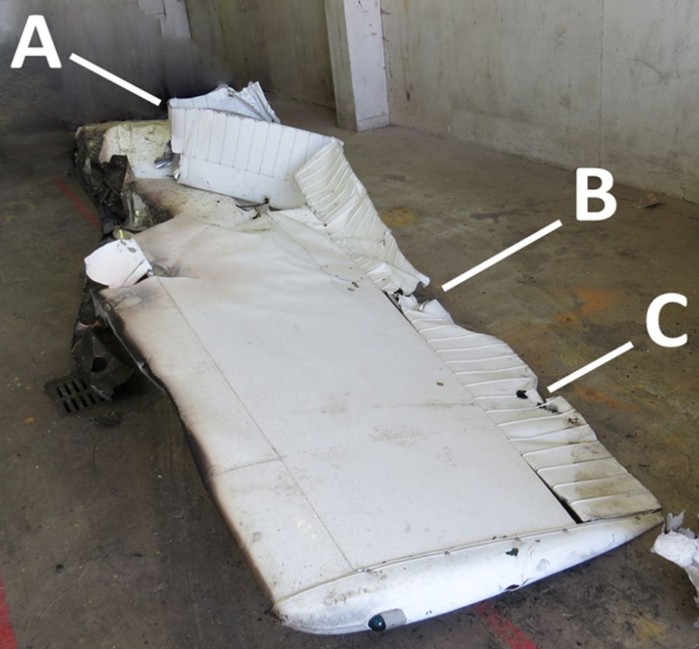 Figure 2. The aircraft’s damaged right wing with dents made by impact with  the power line (A and C) and the cross arm of the hydro pole (B) (Source:  TSB)