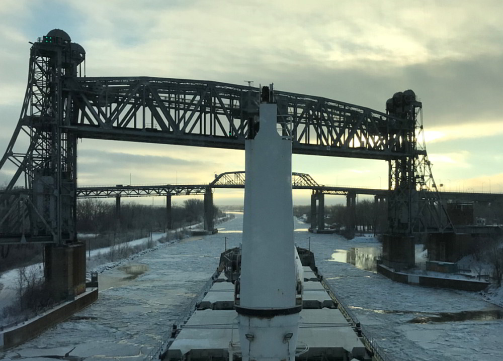   Seaway bridges 7A and 7B with spans lifted, downbound    view. The Honoré-Mercier Bridge is visible in the background. (Source: third party,    with permission)